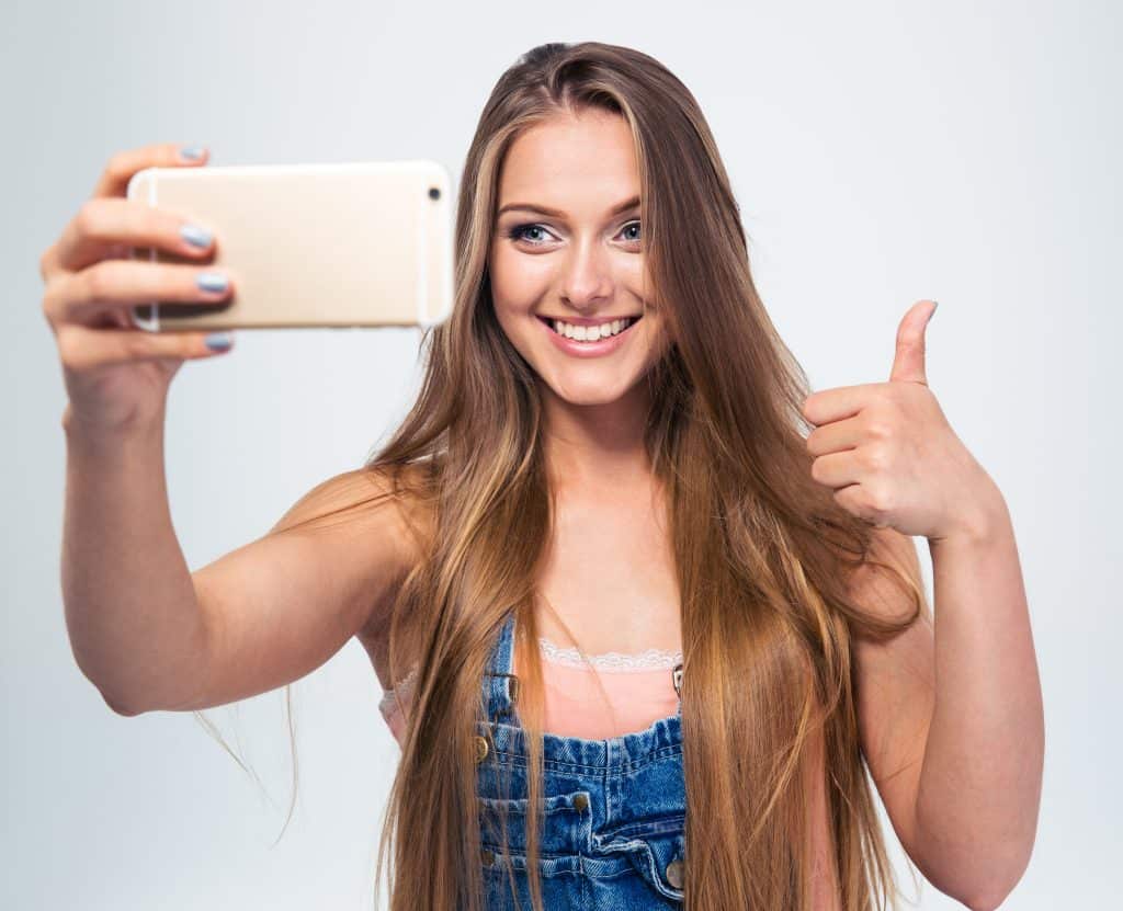 Smiling girl making selfie photo